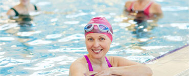 woman in swimming pool smiling