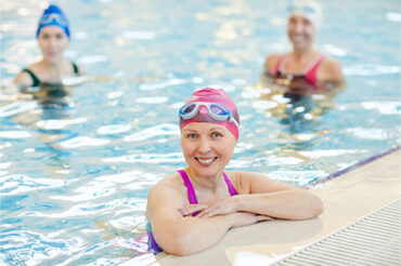 woman in swimming pool smiling