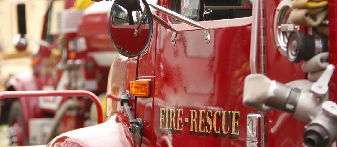 A picture of a fire truck with the words 'Fire & Rescue" written on the driver door.