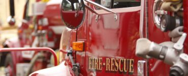 A picture of a fire truck with the words 'Fire & Rescue" written on the driver door.