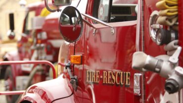 A picture of a fire truck with the words 'Fire & Rescue" written on the driver door.