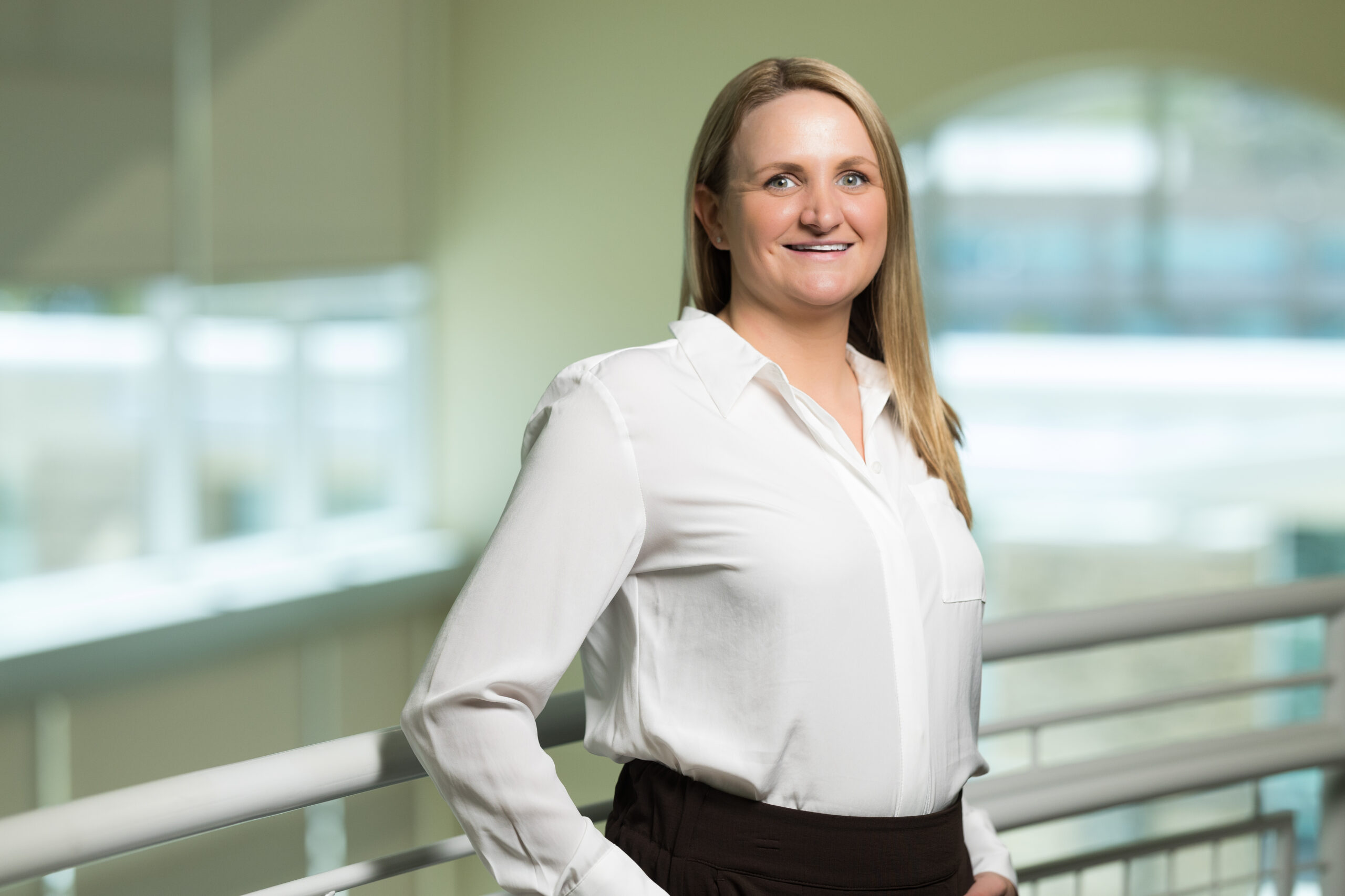 Healthcare provider standing indoors and smiling in a Carson Tahoe Health facility.
