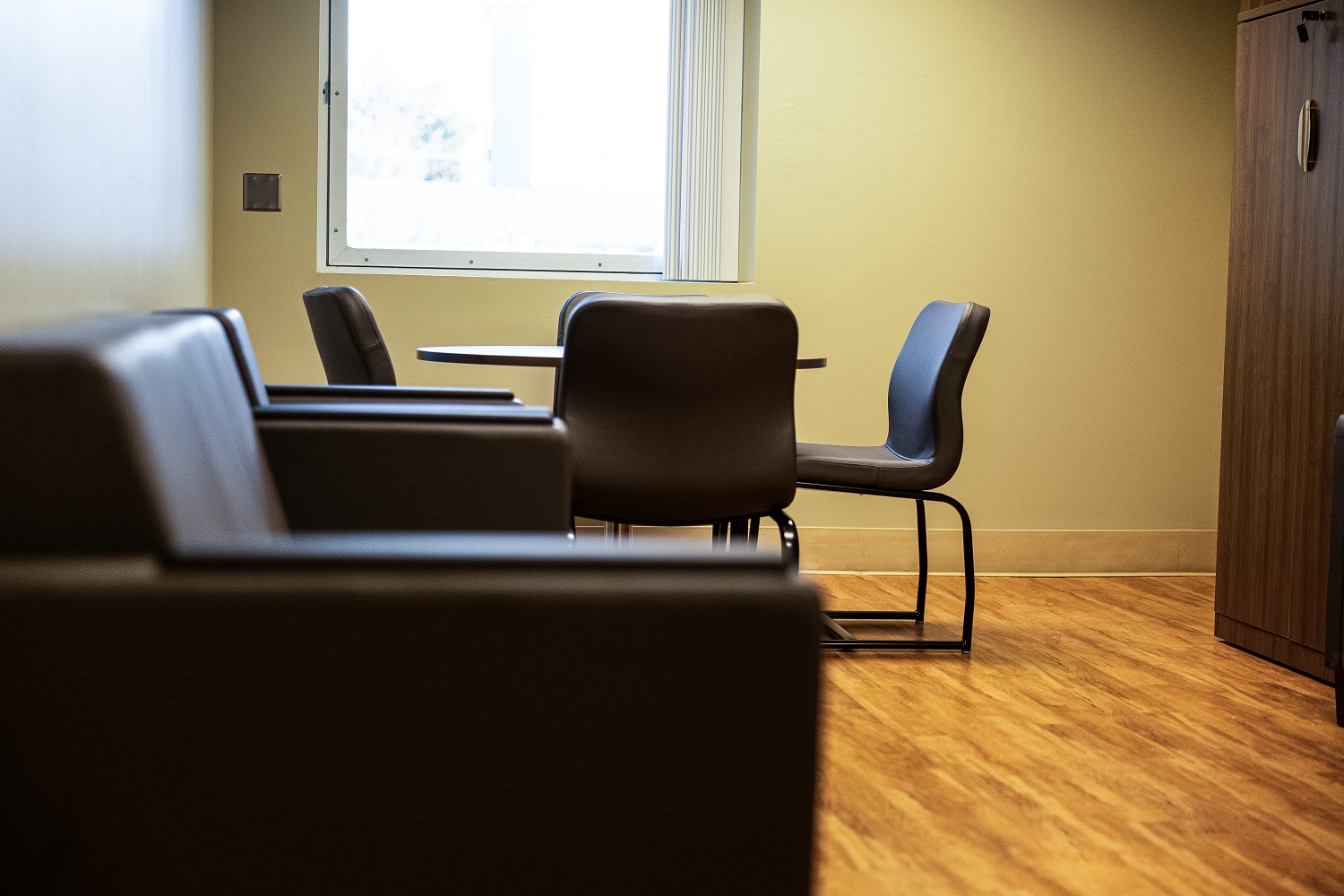 A calm interior room with chairs arranged around a small table inside Carson Tahoe Health’s youth behavioral health facility.