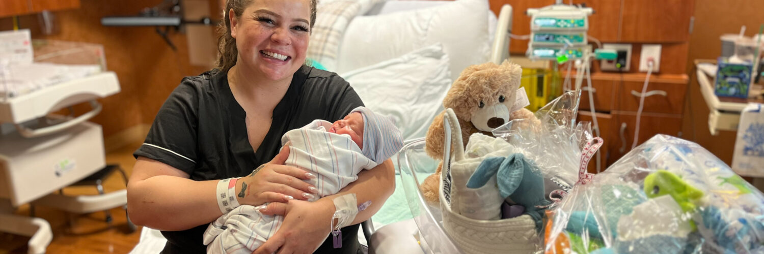 Mother holds newborn baby in a Carson Tahoe Health hospital room on New Year’s Day 2026