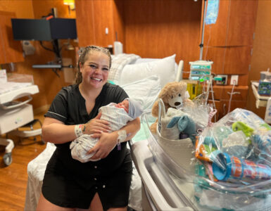 Mother holds newborn baby in a Carson Tahoe Health hospital room on New Year’s Day 2026