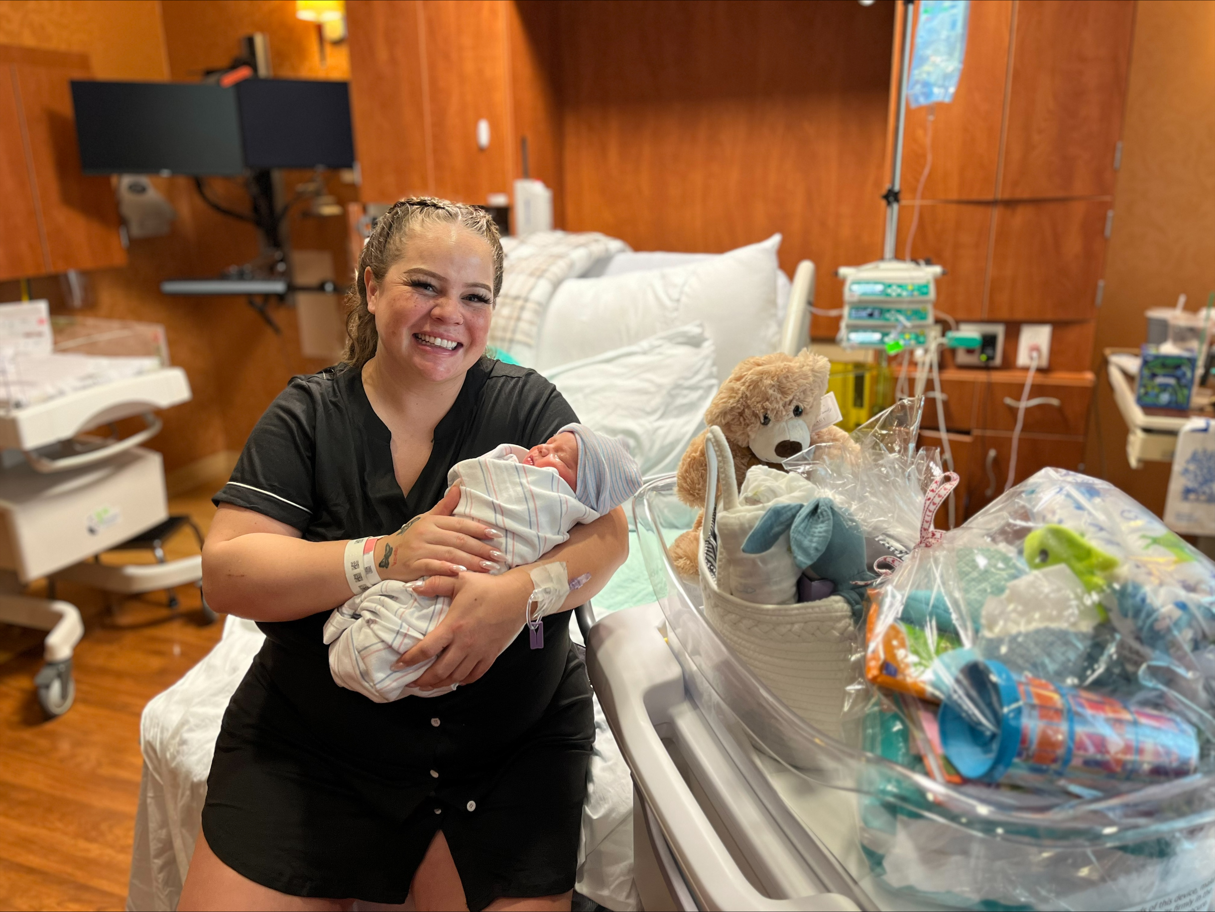 Mother holds newborn baby in a Carson Tahoe Health hospital room on New Year’s Day 2026