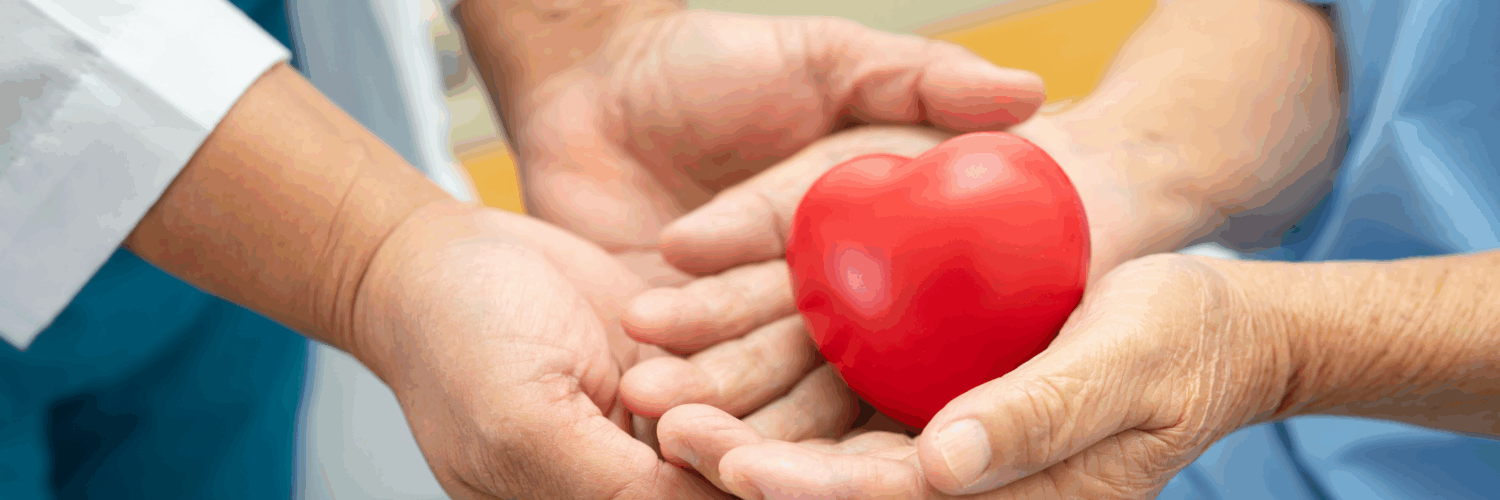 Healthcare professional and patient holding a red heart symbolizing heart health and compassionate care.
