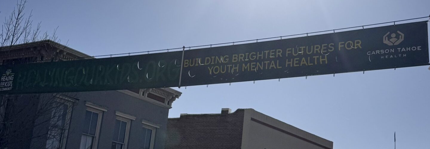 Healing Our Kids banner displayed along Carson Street promoting youth mental health support