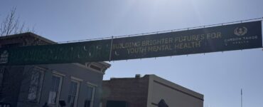 Healing Our Kids banner displayed along Carson Street promoting youth mental health support