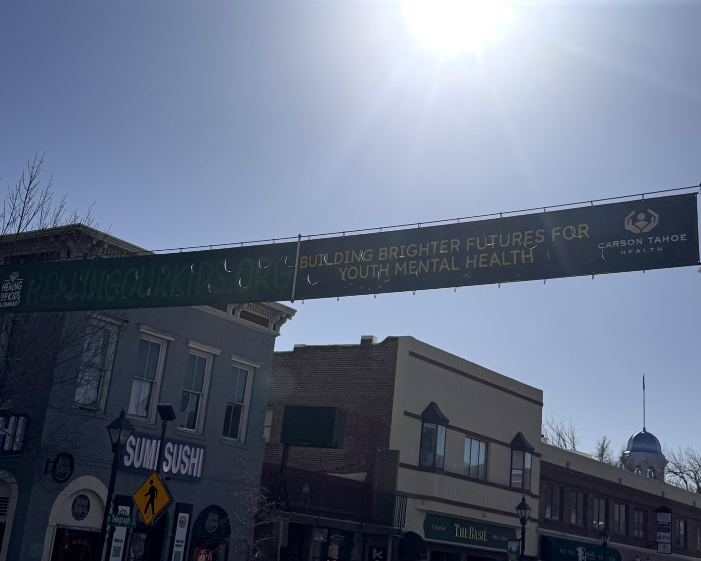 Healing Our Kids banner displayed along Carson Street promoting youth mental health support