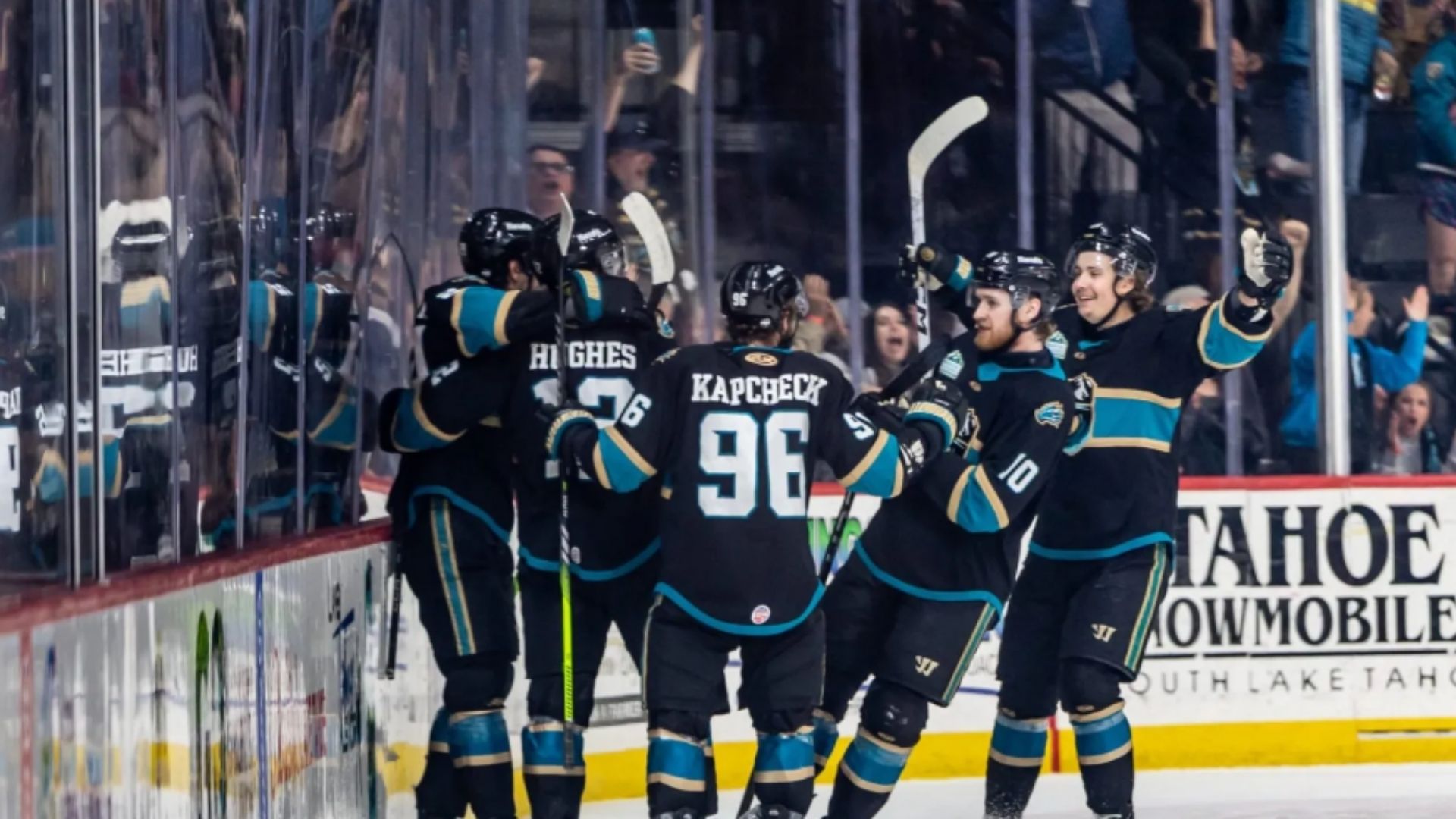 Tahoe Knight Monsters hockey players celebrating a goal on the ice during a game