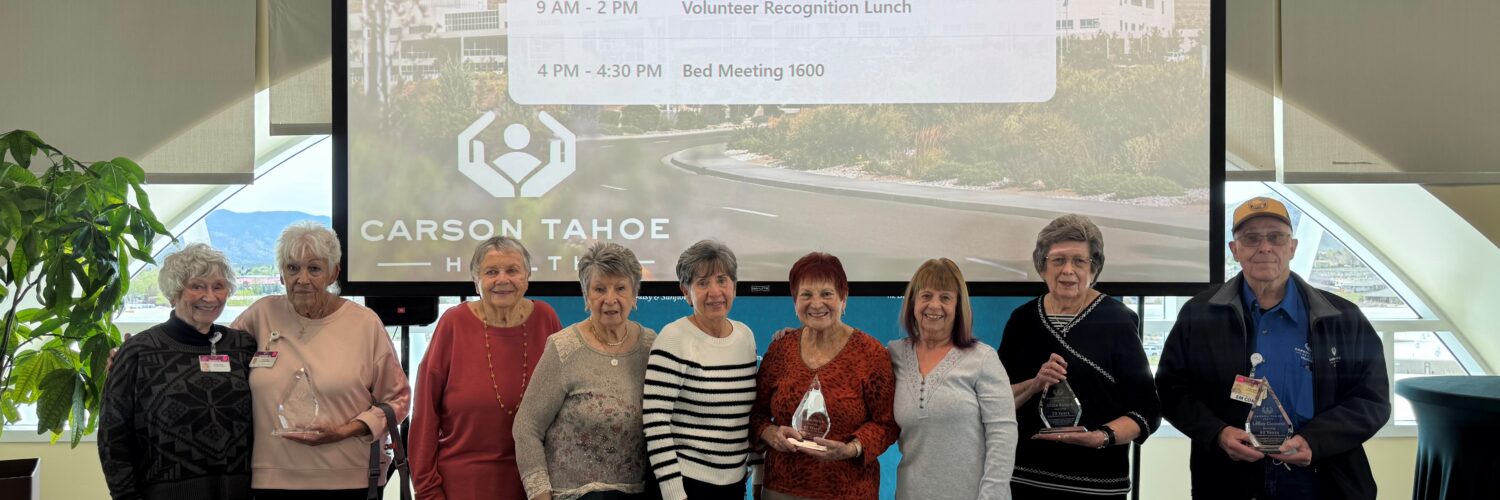 Carson Tahoe Health volunteers recognized during National Volunteer Week holding awards at volunteer appreciation event