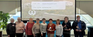 Carson Tahoe Health volunteers recognized during National Volunteer Week holding awards at volunteer appreciation event