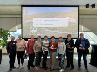 Carson Tahoe Health volunteers recognized during National Volunteer Week holding awards at volunteer appreciation event
