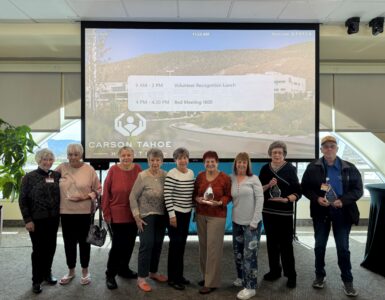 Carson Tahoe Health volunteers recognized during National Volunteer Week holding awards at volunteer appreciation event