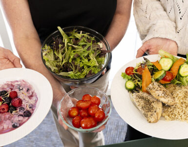 Healthy meal with salad, quinoa, grilled chicken, fresh vegetables, and berry yogurt for balanced nutrition