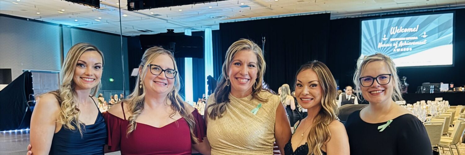 Carson Tahoe Health team members dressed in formal attire at the 2026 Nurses of Achievement Awards event, smiling together at a banquet venue.