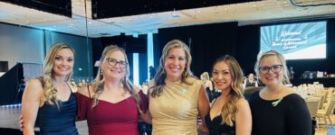Carson Tahoe Health team members dressed in formal attire at the 2026 Nurses of Achievement Awards event, smiling together at a banquet venue.