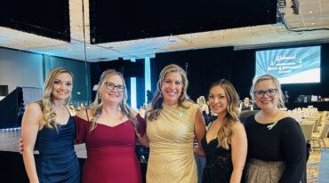 Carson Tahoe Health team members dressed in formal attire at the 2026 Nurses of Achievement Awards event, smiling together at a banquet venue.