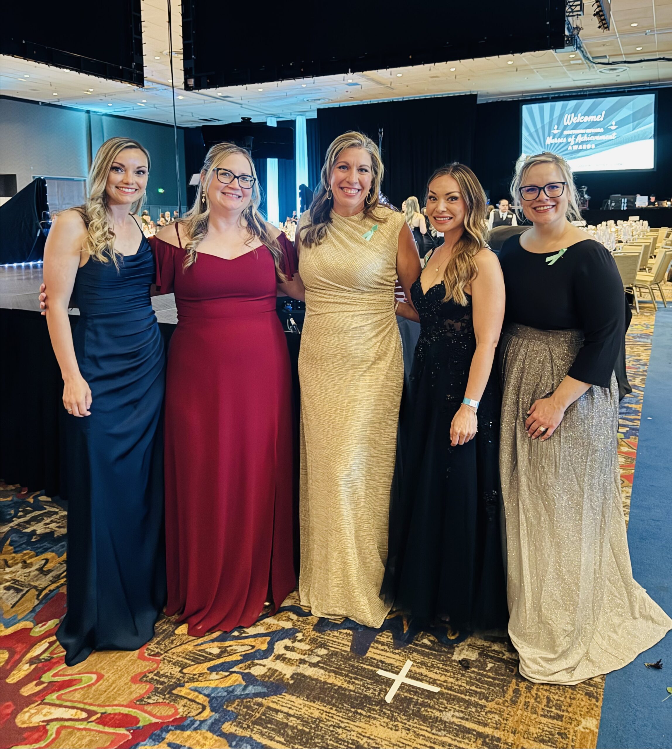 Carson Tahoe Health team members dressed in formal attire at the 2026 Nurses of Achievement Awards event, smiling together at a banquet venue.
