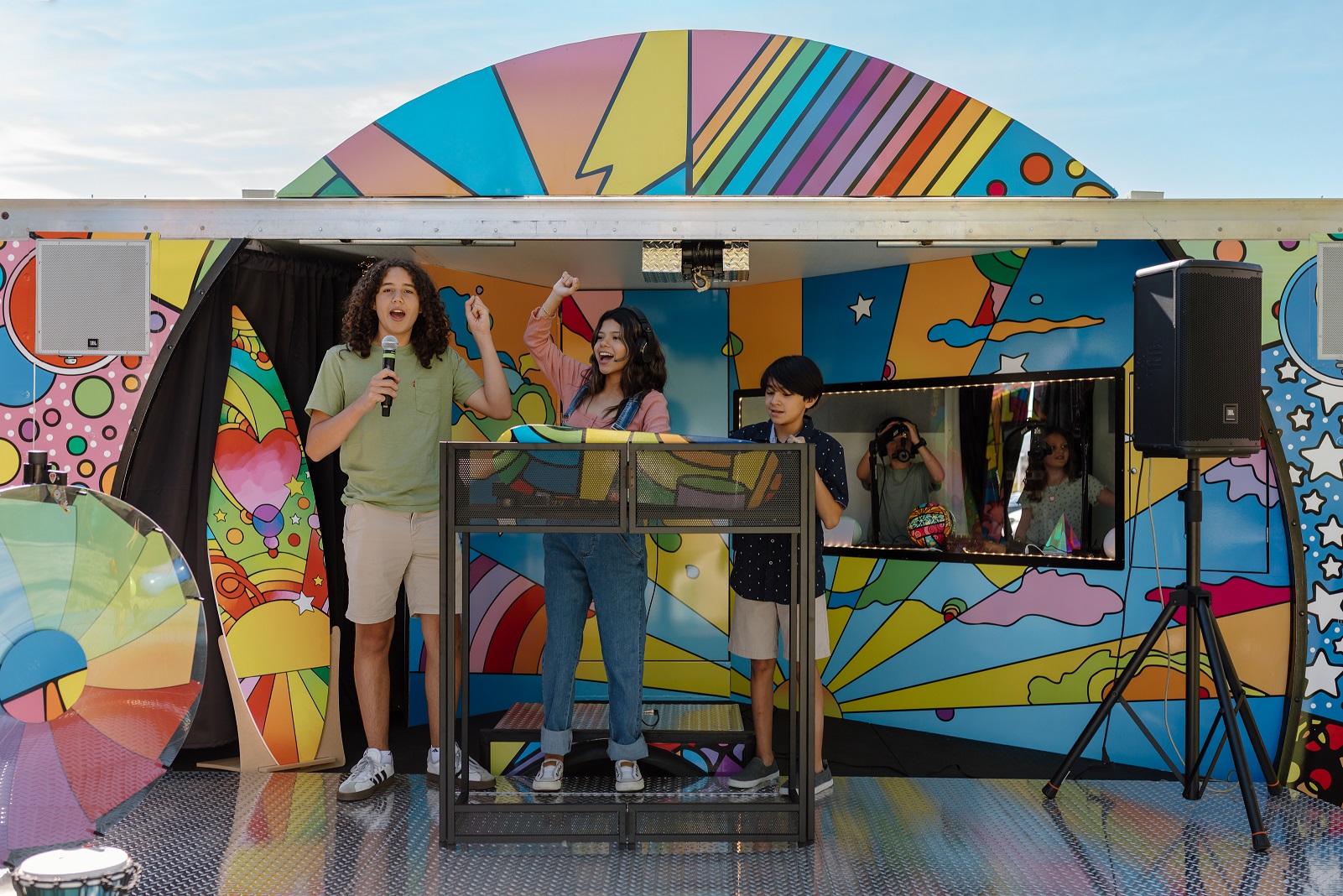 Children participating in a music and podcast activity inside the Sound Ideas outreach vehicle