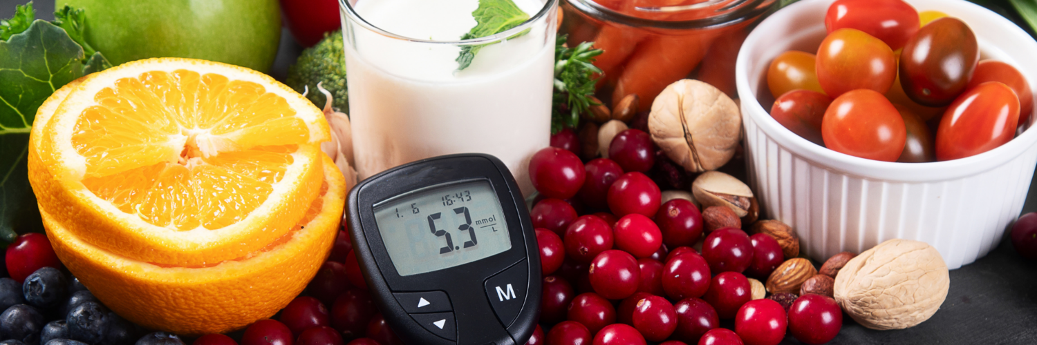 Healthy foods including fruits, vegetables, nuts, and milk with a glucose meter showing blood sugar levels, representing diabetes prevention and healthy lifestyle