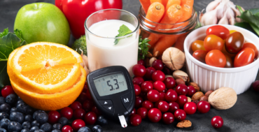 Healthy foods including fruits, vegetables, nuts, and milk with a glucose meter showing blood sugar levels, representing diabetes prevention and healthy lifestyle