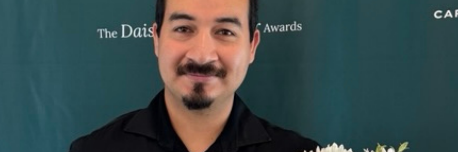 Juan Juarez Razo holding his DAISY Award and flowers at Carson Tahoe Health
