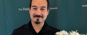 Juan Juarez Razo holding his DAISY Award and flowers at Carson Tahoe Health
