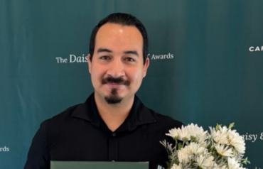 Juan Juarez Razo holding his DAISY Award and flowers at Carson Tahoe Health