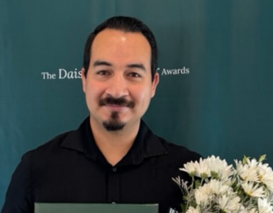 Juan Juarez Razo holding his DAISY Award and flowers at Carson Tahoe Health