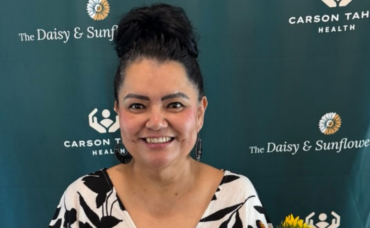 Alba Alegria holding her Sunflower Award and a bouquet of sunflowers at Carson Tahoe Health