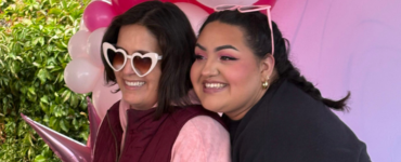 Two women smile in front of a pink balloon arch at Carson Tahoe Health’s Think Pink+ event in Carson City.