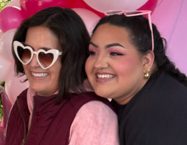 Two women smile in front of a pink balloon arch at Carson Tahoe Health’s Think Pink+ event in Carson City.